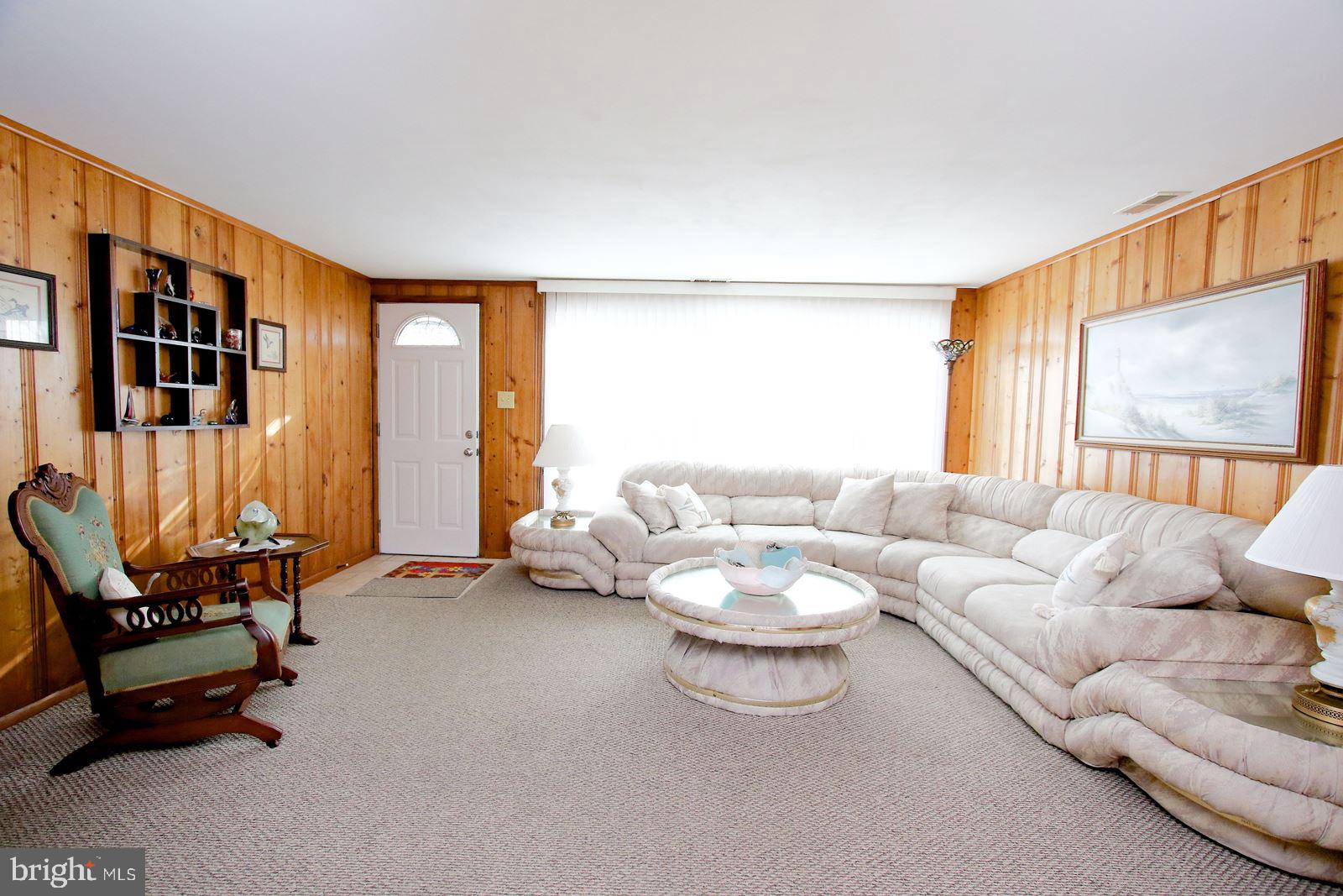 45 Amherst Road Long Beach Township, NJ 08006 - Photo 5 of 35 entry to street side, sunny living room