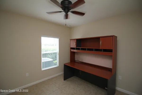 a view of an empty room with wooden floor and a cabinet