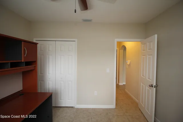 a bathroom with a granite countertop bathtub shower sink vanity and toilet