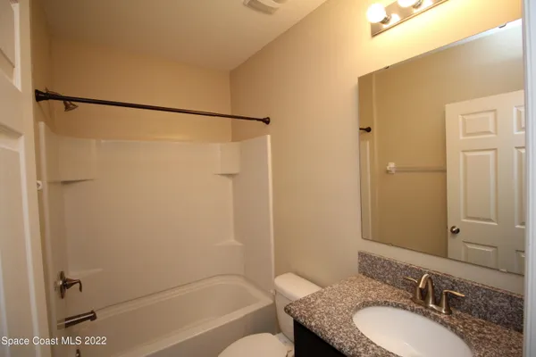 a bathroom with a shower and a toilet