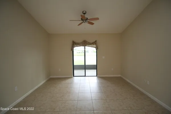 a view of an empty room and a window