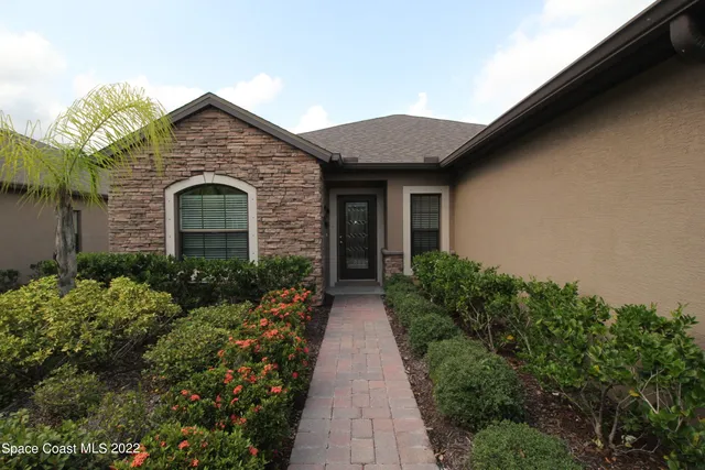 a front view of a house with garden