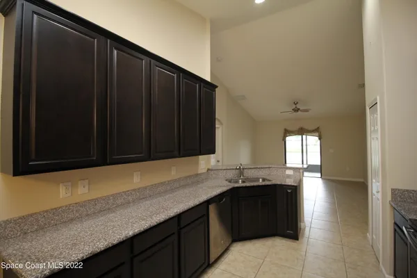 a kitchen with granite countertop stainless steel appliances and wooden cabinets