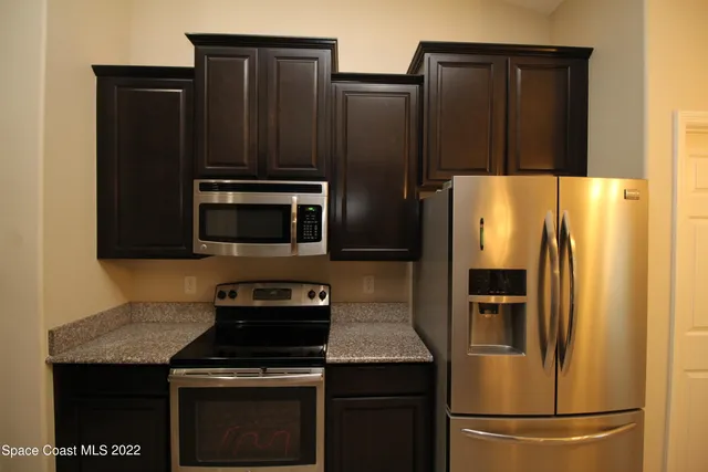 a white refrigerator freezer sitting in a kitchen