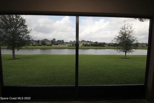 a front view of a house with a garden and yard
