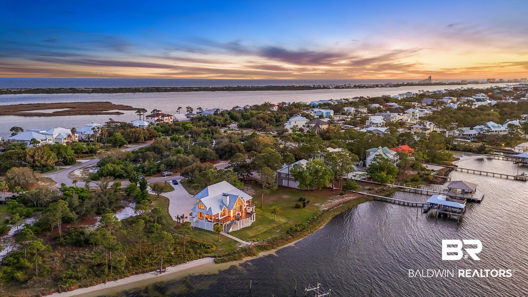 33349 River Road Orange Beach, AL 36561 - Photo 47 of 61 Waterfront residence featuring multiple balconies, a private pier with boat slips, and a white metal roof