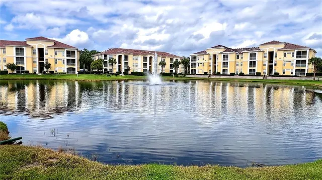 a view of a house next to a lake with a city view