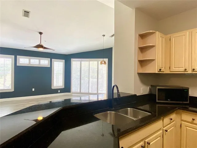 a kitchen with a sink and a large window