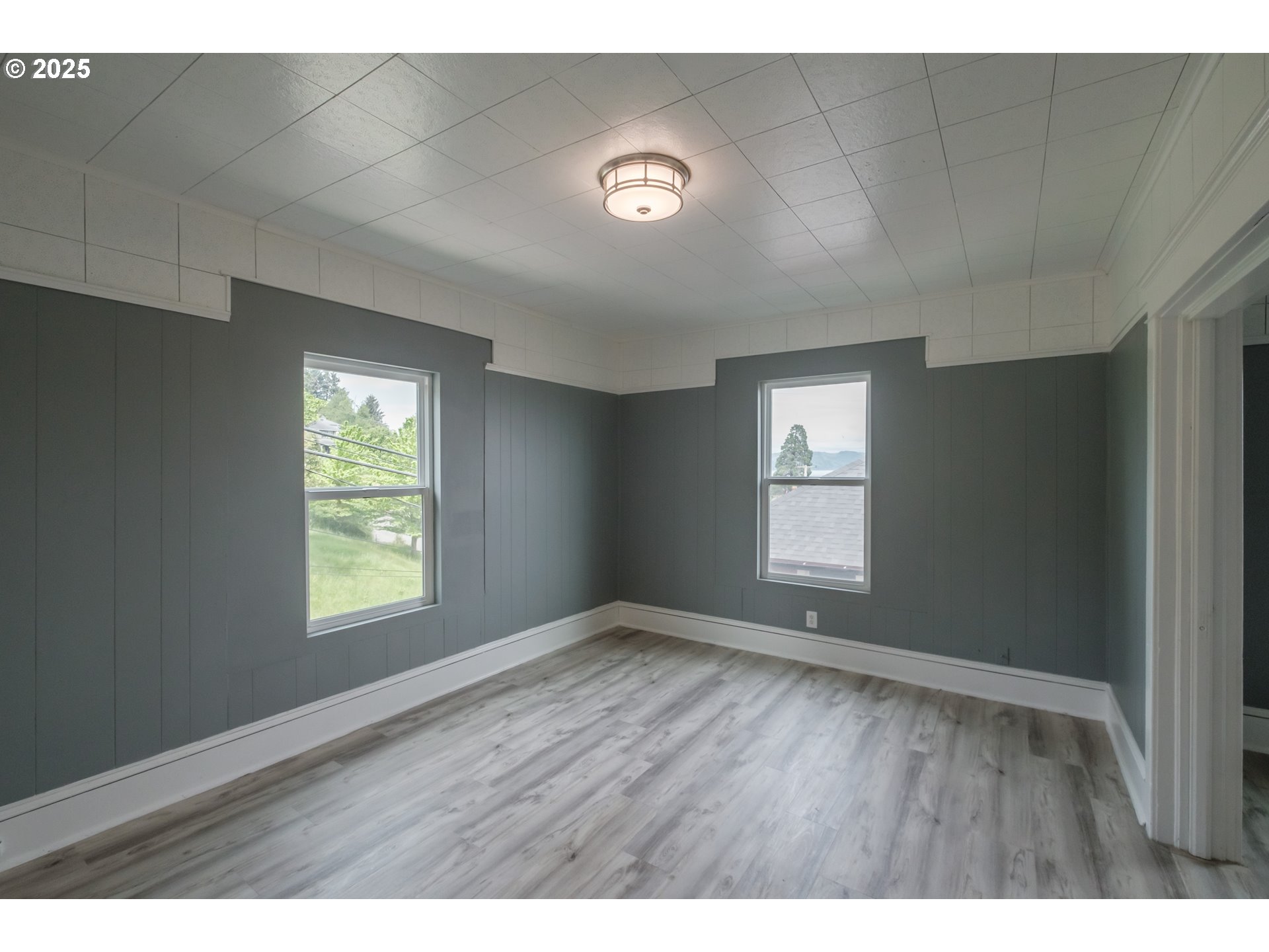640 8th Street Astoria, OR 97103 - Photo 6 of 21 a view of an empty room with wooden floor and a window