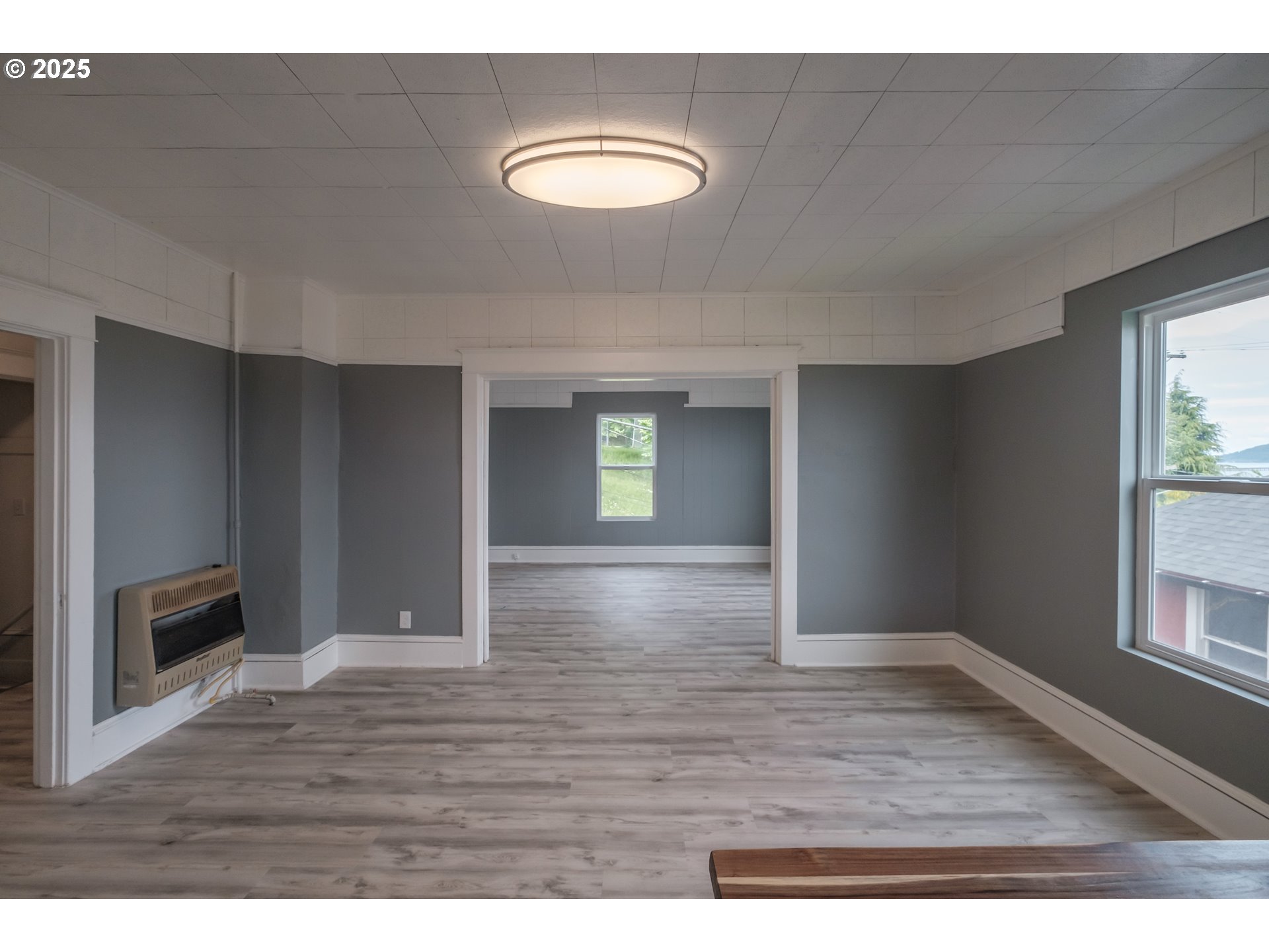 640 8th Street Astoria, OR 97103 - Photo 7 of 21 a view of an empty room with window and wooden floor