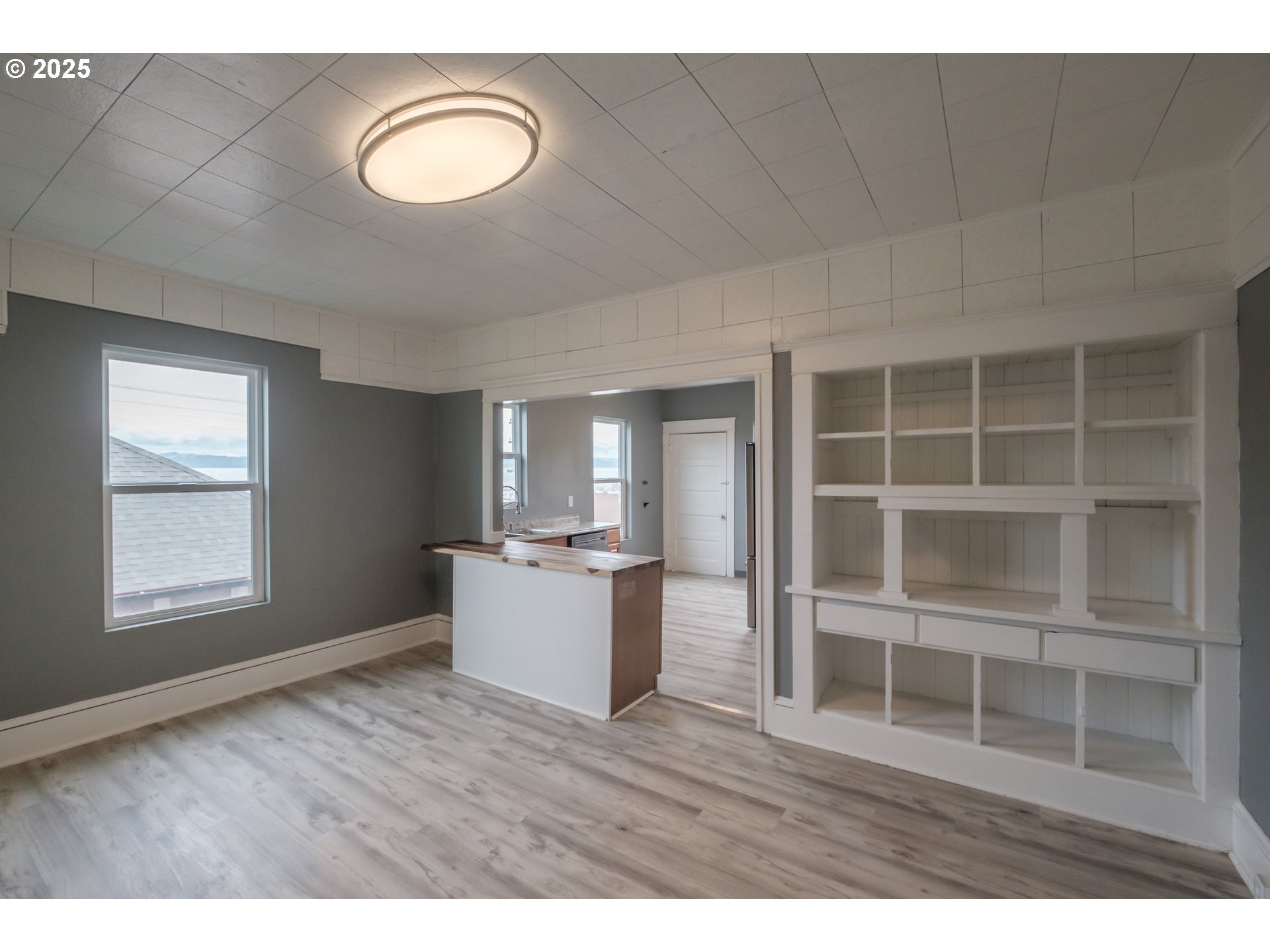 640 8th Street Astoria, OR 97103 - Photo 8 of 21 a view of empty room with a window and wooden floor