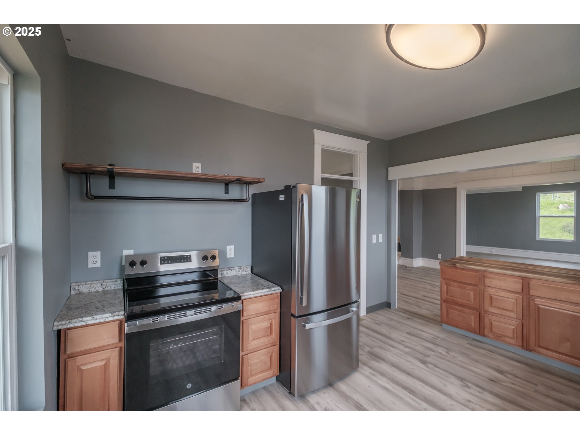 640 8th Street Astoria, OR 97103 - Photo 9 of 21 a kitchen with refrigerator cabinets and wooden floor