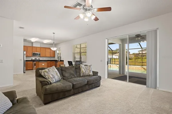 a view of a livingroom with furniture and a ceiling fan