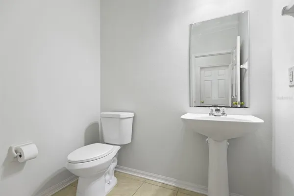 a bathroom with a sink a toilet and mirror