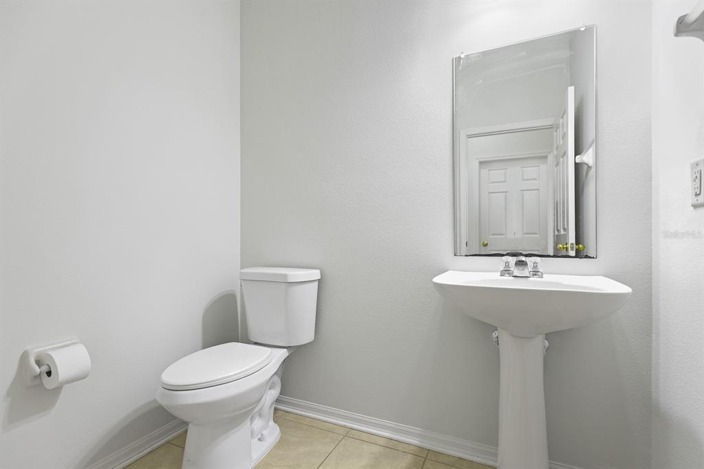 1411 Main Street Valrico, FL 33594 - Photo 18 of 44 a bathroom with a sink a toilet and mirror