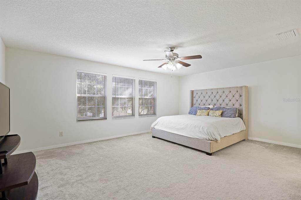 1411 Main Street Valrico, FL 33594 - Photo 19 of 44 a spacious bedroom with a bed and window