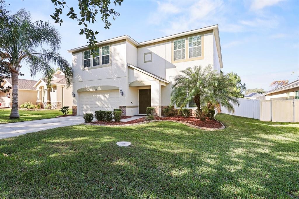 1411 Main Street Valrico, FL 33594 - Photo 2 of 44 a view of a house with a yard patio and swimming pool