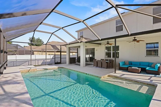 a view of a backyard with furniture and a patio
