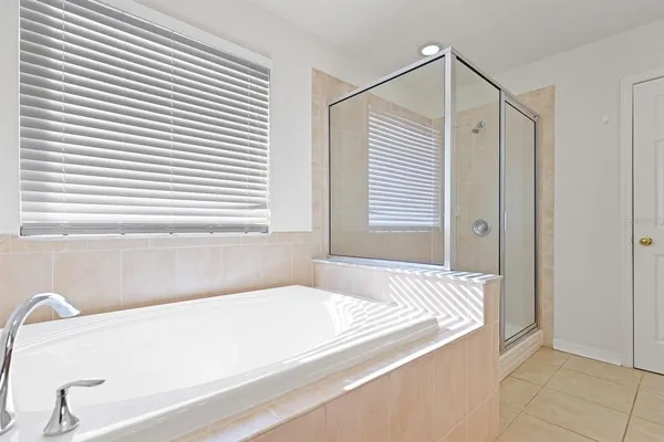 a bathroom with a bathtub and a window