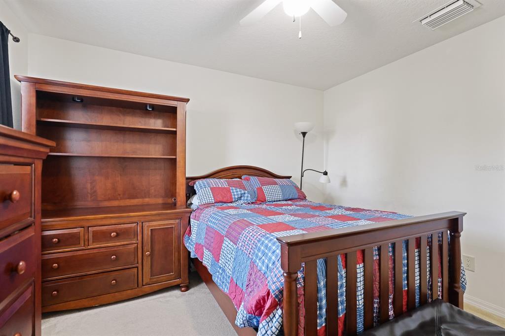 1411 Main Street Valrico, FL 33594 - Photo 28 of 44 a bedroom with a bed and furniture