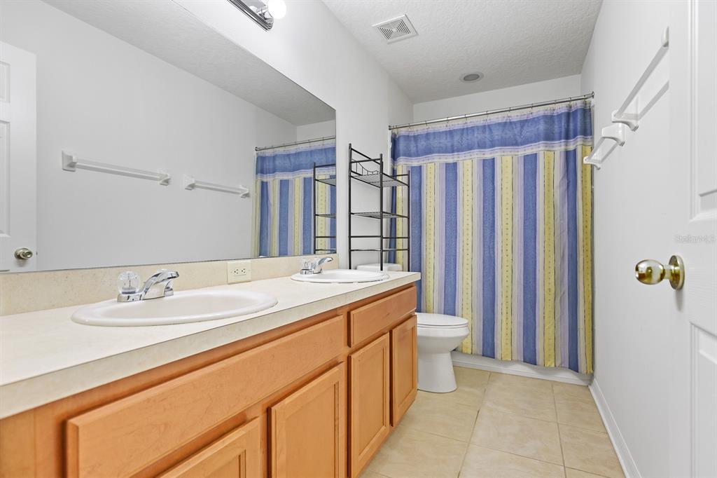 1411 Main Street Valrico, FL 33594 - Photo 29 of 44 a spacious bathroom with a double vanity sink mirror and toilet