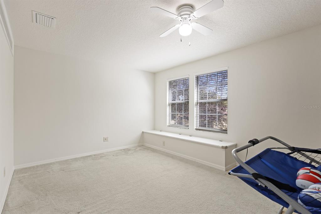 1411 Main Street Valrico, FL 33594 - Photo 32 of 44 an empty room with windows and fan