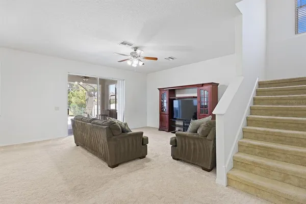 a living room with furniture and stairs