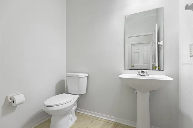 a bathroom with a sink a toilet and mirror