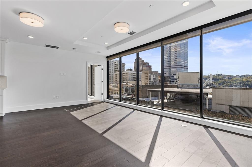 350 Oliver Avenue, Unit 1605 Pittsburgh, PA 15222 - Photo 11 of 40 a view of an empty room with a floor to ceiling window and an outdoor view
