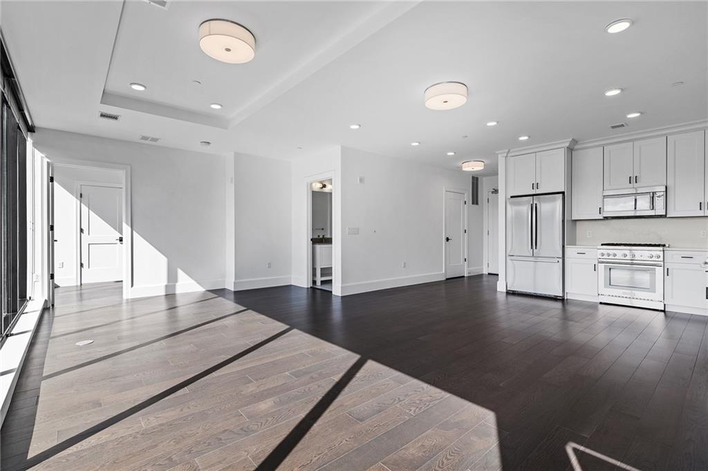 350 Oliver Avenue, Unit 1605 Pittsburgh, PA 15222 - Photo 2 of 40 a view of a kitchen with a refrigerator and a stove top oven