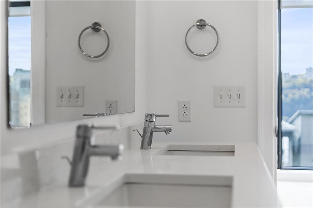 350 Oliver Avenue, Unit 1605 Pittsburgh, PA 15222 - Photo 23 of 40 a bathroom with a sink mirror and vanity