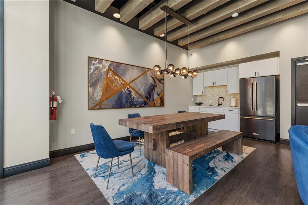 350 Oliver Avenue, Unit 1605 Pittsburgh, PA 15222 - Photo 27 of 40 a kitchen with stainless steel appliances a stove a refrigerator and a dining table