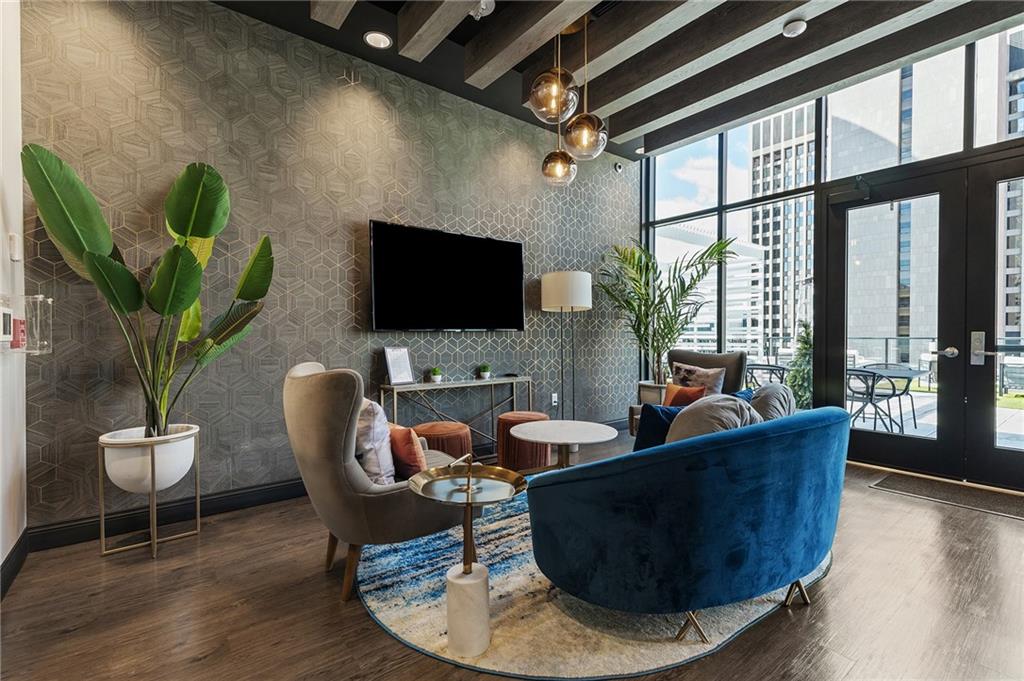350 Oliver Avenue, Unit 1605 Pittsburgh, PA 15222 - Photo 28 of 40 a living room with furniture a flat screen tv and a potted plant