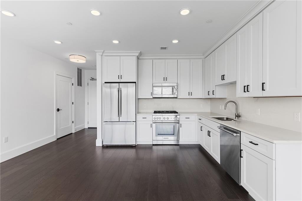 350 Oliver Avenue, Unit 1605 Pittsburgh, PA 15222 - Photo 4 of 40 a kitchen with stainless steel appliances granite countertop a refrigerator sink and white cabinets