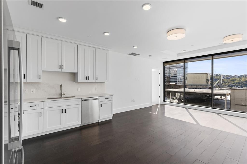 350 Oliver Avenue, Unit 1605 Pittsburgh, PA 15222 - Photo 5 of 40 a large kitchen with stainless steel appliances a large window and a sink