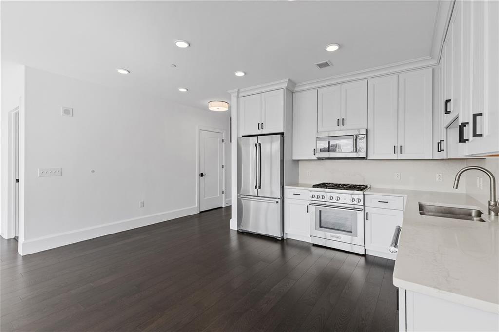 350 Oliver Avenue, Unit 1605 Pittsburgh, PA 15222 - Photo 6 of 40 a kitchen with stainless steel appliances granite countertop a refrigerator sink and white cabinets