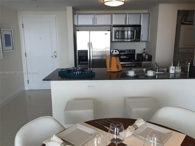 a bathroom with a sink a toilet a mirror and shower