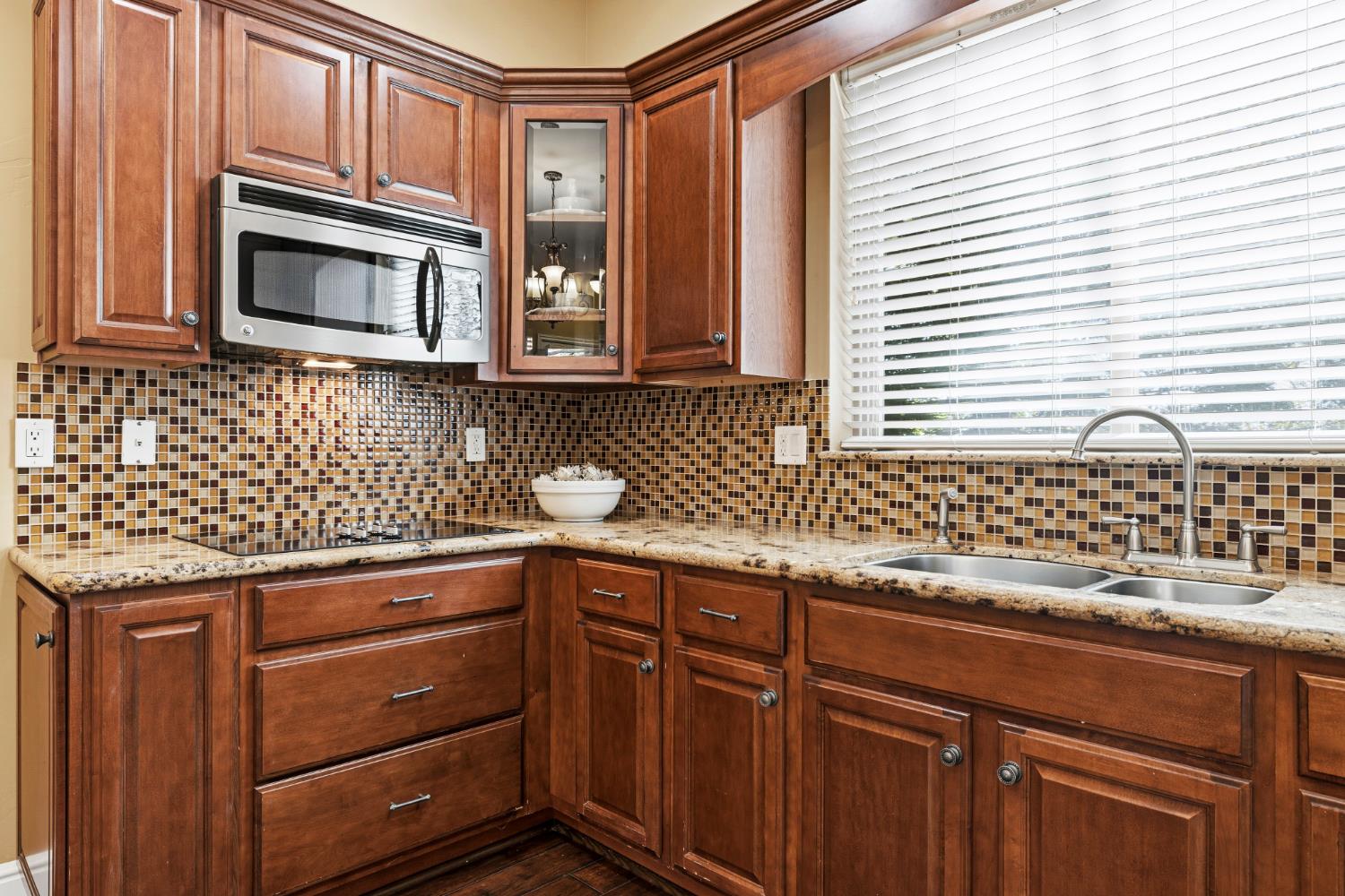 3047 Travois Circle Rescue, CA 95672 - Photo 24 of 94 a kitchen with granite countertop cabinets stainless steel appliances a sink and a window