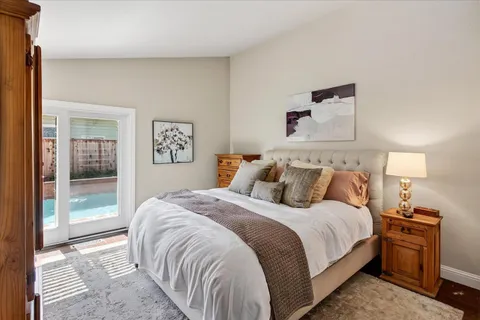 a bedroom with a bed and a night stand