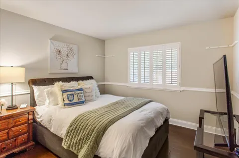 a bathroom with a sink a toilet a mirror a vanity and shower