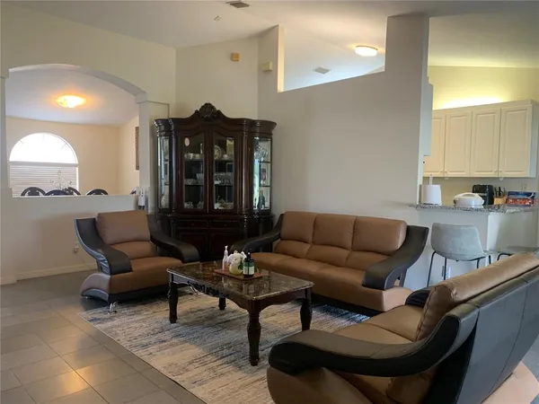 a living room with furniture and a lamp