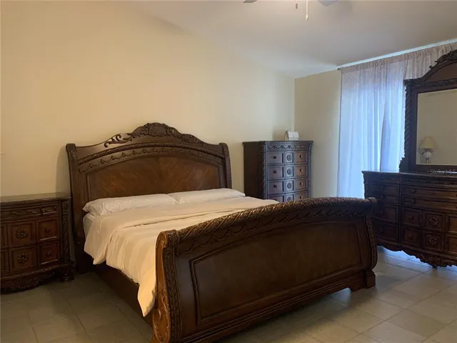 a bedroom with a bed and a television