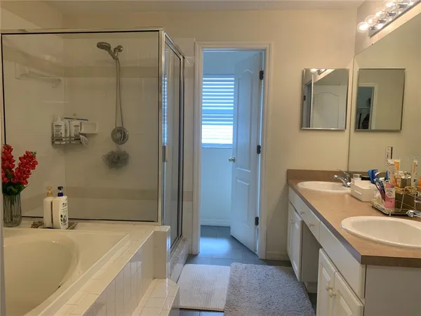 a bathroom with a tub sink and mirror