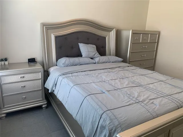 a bedroom with a bed and a cabinets