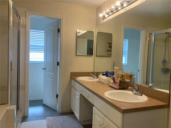 a bathroom with a sink double vanity and a mirror