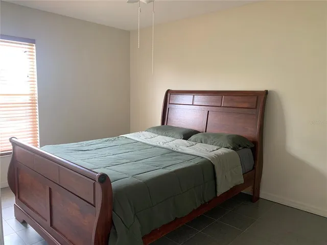 a bedroom with a bed and a window