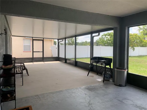 a living room with furniture a floor to ceiling window and a flat screen tv
