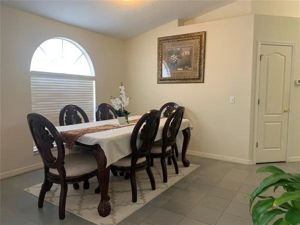 a view of a dining room with furniture and a window