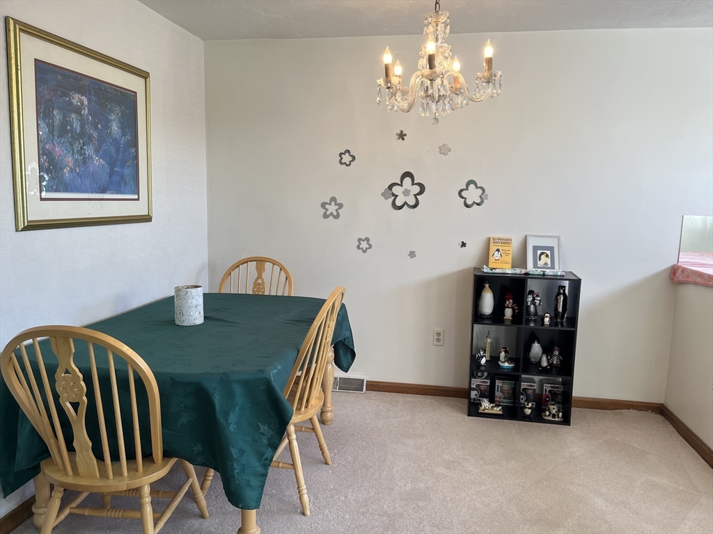 51 Londonderry Road, Unit 51 Grafton, MA 01519 - Photo 3 of 32 a view of a dining room with furniture and chandelier