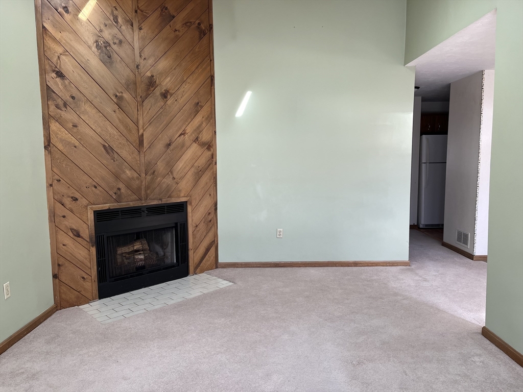 51 Londonderry Road, Unit 51 Grafton, MA 01519 - Photo 7 of 32 a view of an empty room with a fireplace